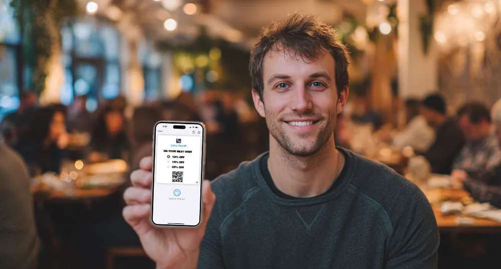 Loyalty Programs 5 Loyalty Programs for Food Service man with mobile phone with loyalty card in hand